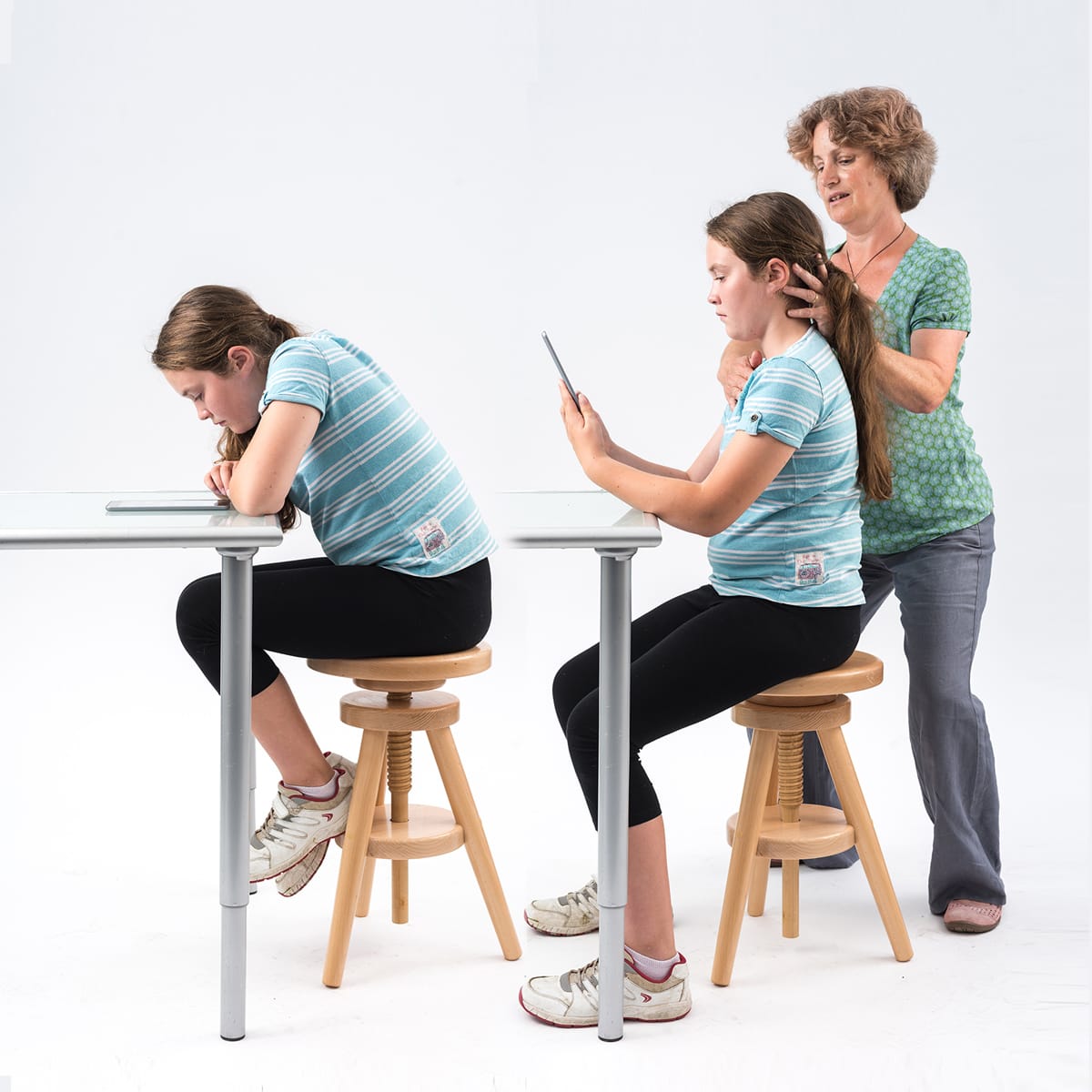 Rebecca showing a child how to sit at a table